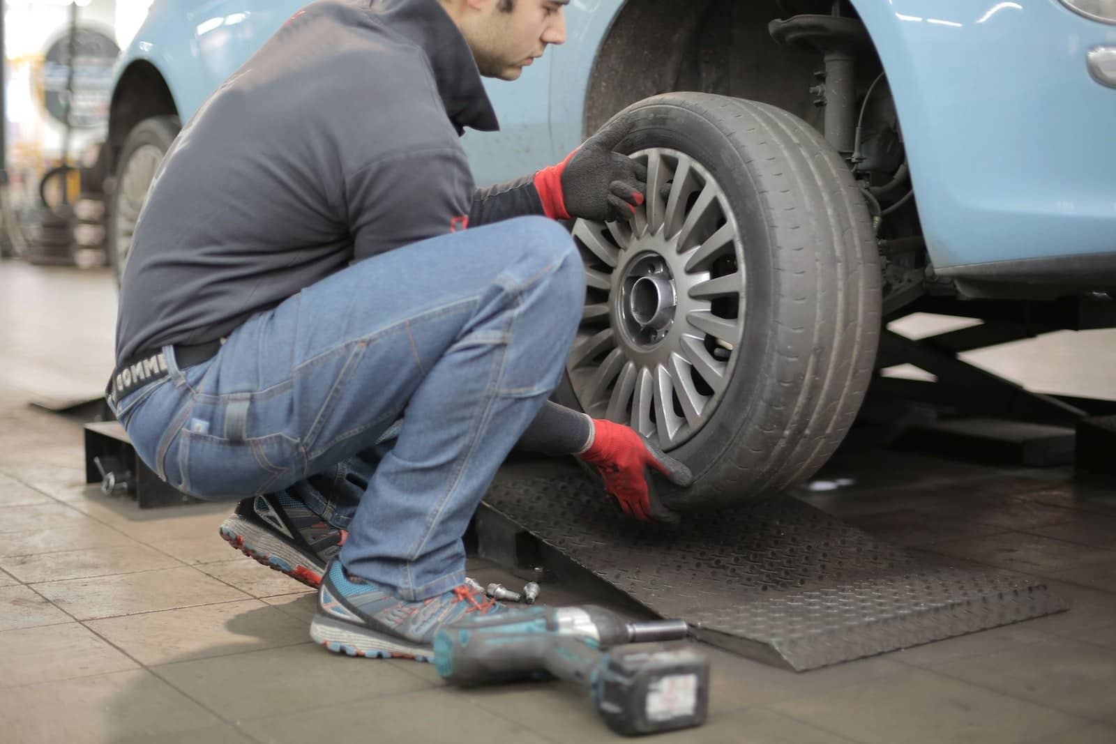 Man Changing/mounting a Car Tire
